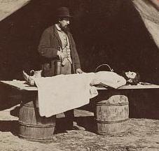 Photograph shows Dr. Richard Burr, an embalming surgeon in the Army of the James demonstrating the procedure on a dead soldier.