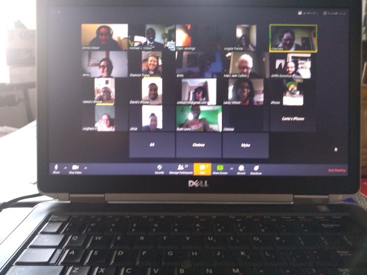 An open laptop to a Zoom Video Conference with 23 people celebrating a birthday