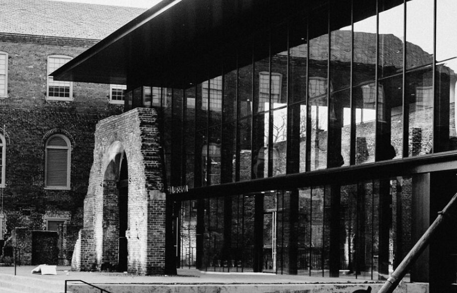A black and white image of the outside of the Tredegar location with the Tredegar arch on the left and the building to the right