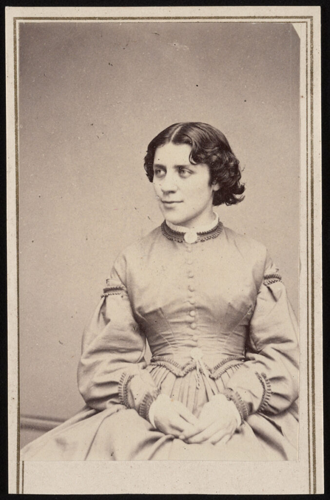 A portrait of Anna Dickinson, seated, looking to the right of the camera.